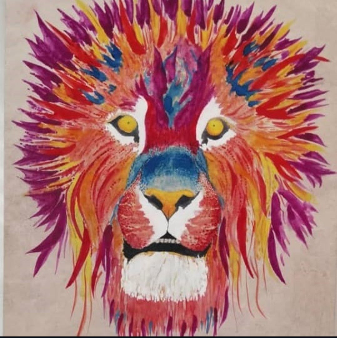 A lion’s head in vivid red, magenta and blue strokes, watercolor on stone